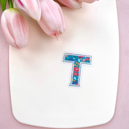 Letter 'T' sticker with floral design on a white background with pink tulips.