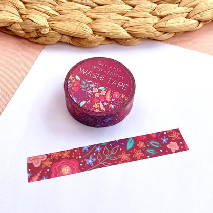 Washi tape with floral design on a white surface next to a woven mat