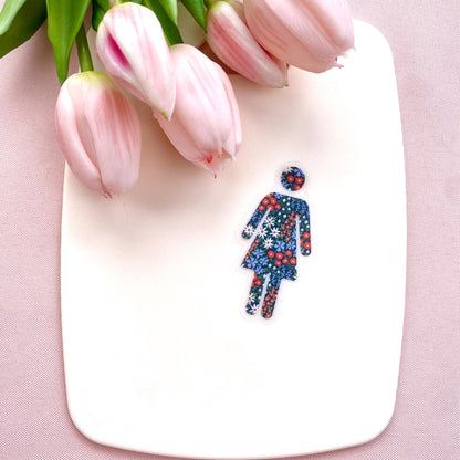 Clear transparent with floral patterned woman silhouette against a cream background with pink tulips.