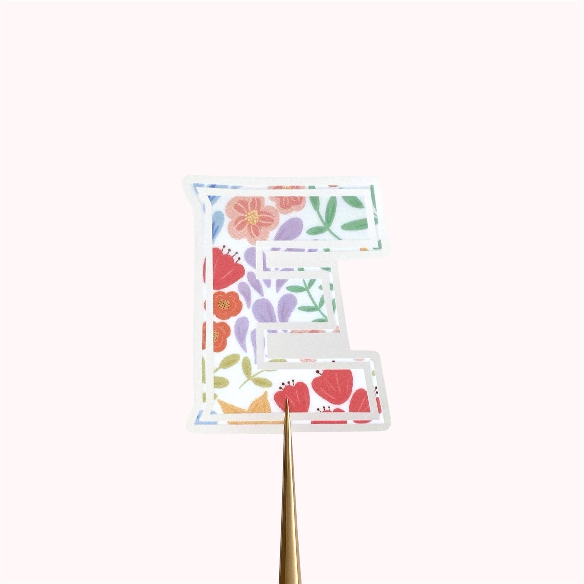 Letter 'E' sticker with floral design on a white background