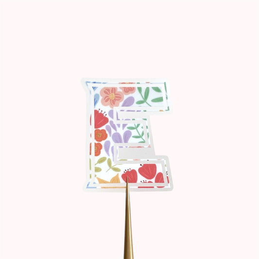 Letter 'E' sticker with floral design on a white background