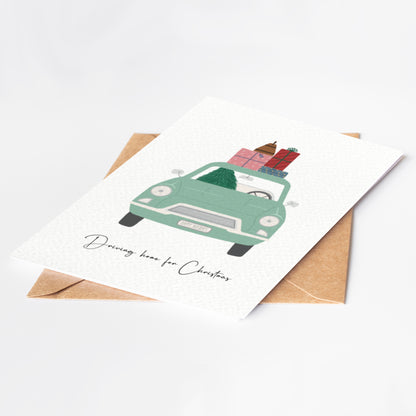 Greeting card with a green car carrying Christmas presents on a white background