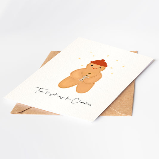 Greeting card with a gingerbread man illustration and envelope on a white background