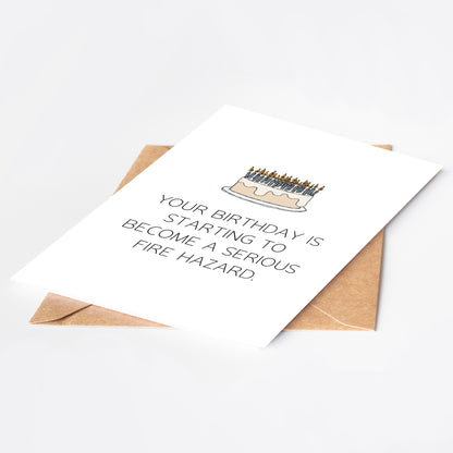 Birthday card with cake illustration and humorous text on a white background