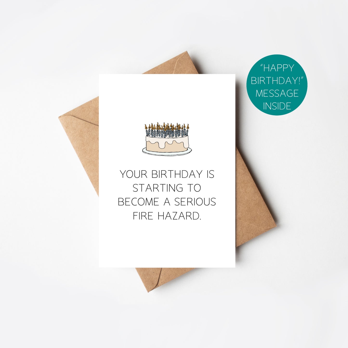 Birthday card with cake illustration and humorous text, accompanied by a brown envelope on a white background.