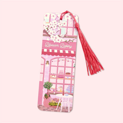 Bookmark with a pink bakery design and bright pink tassel on a light pink background