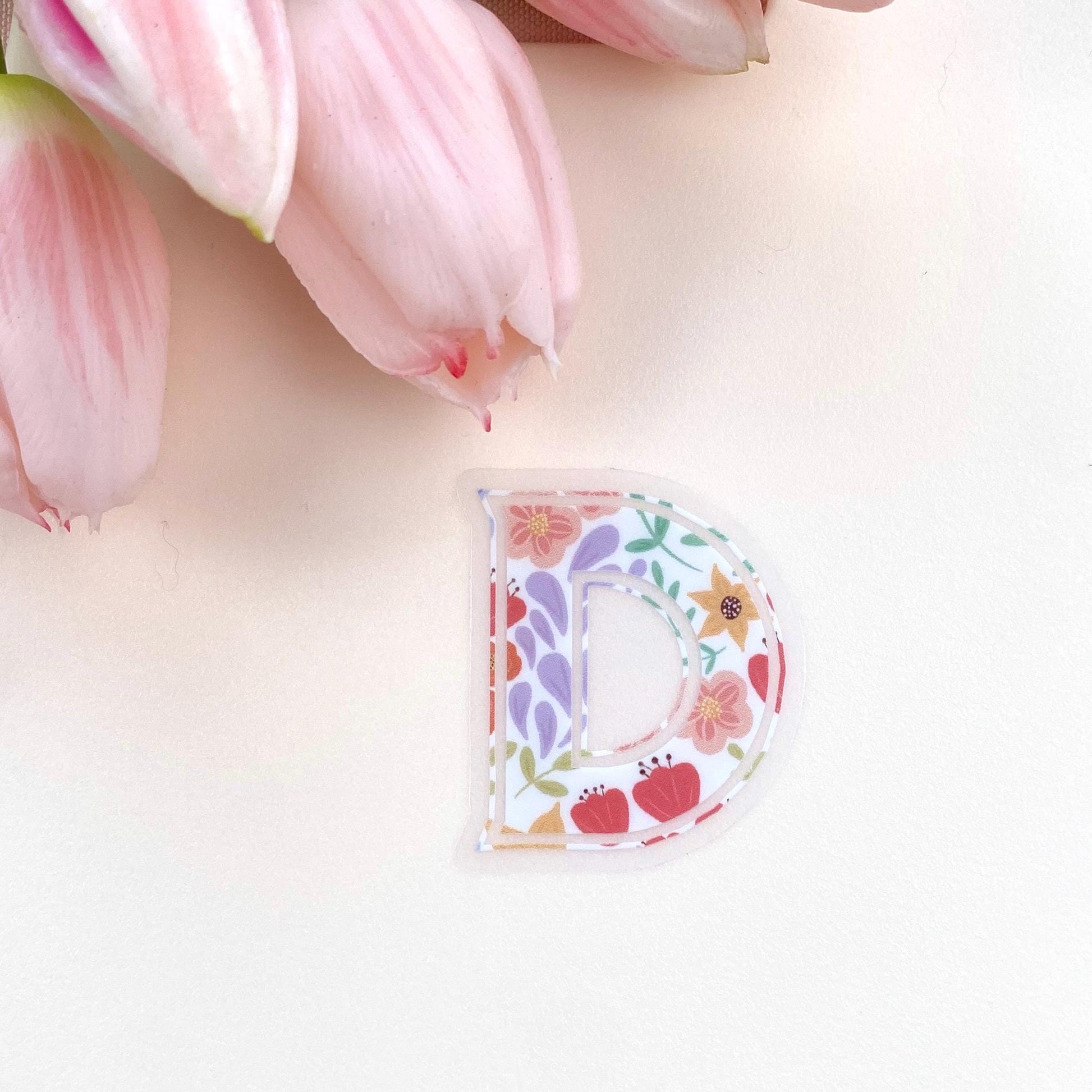 Decorative letter 'P' sticker with floral designs on a white background