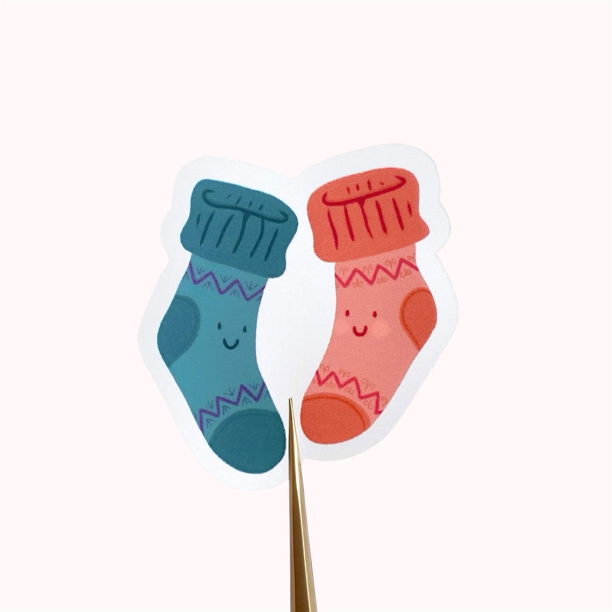 A sticker with two colourful socks with smiley faces on a white background