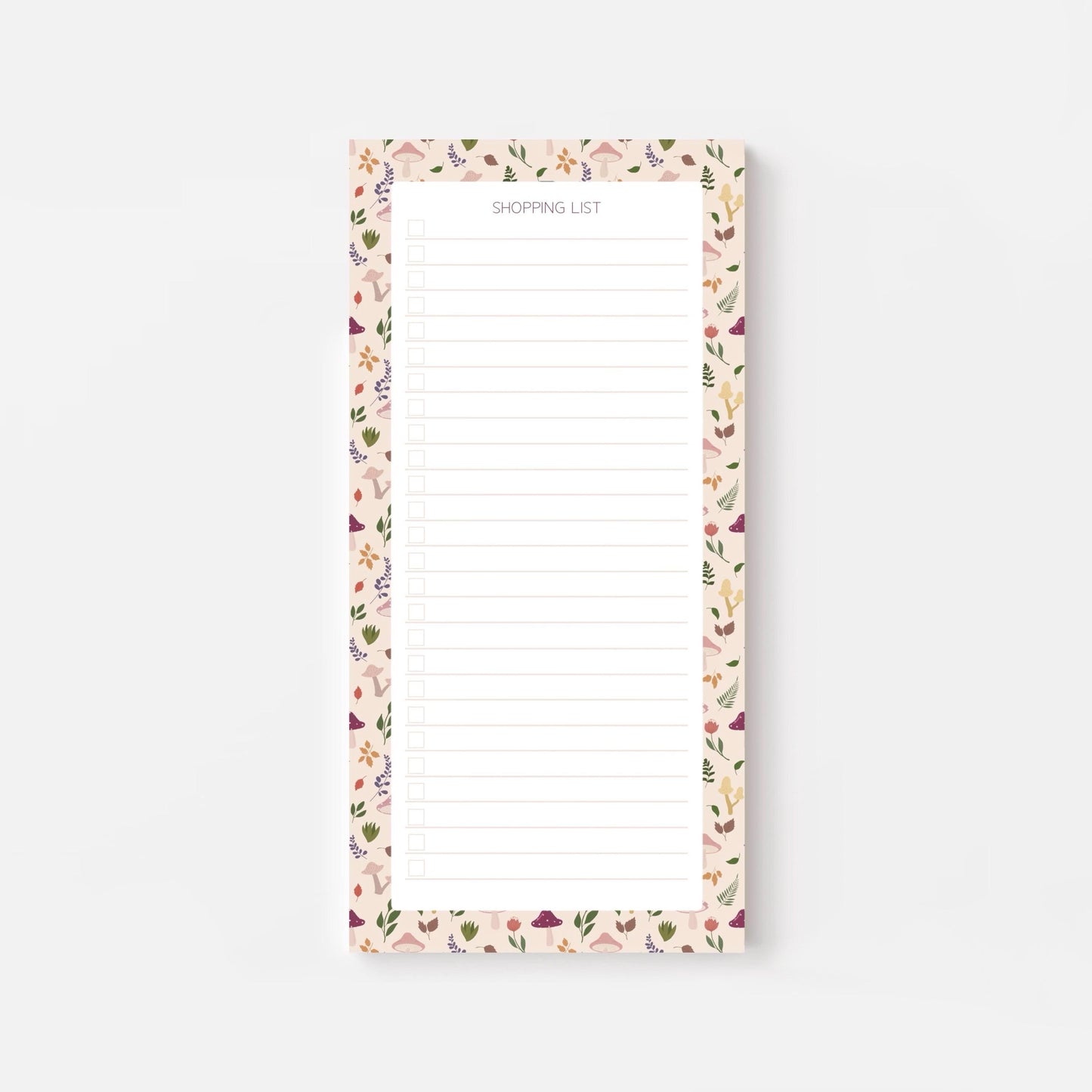 Autumn foliage-patterned shopping list notepad on a white background