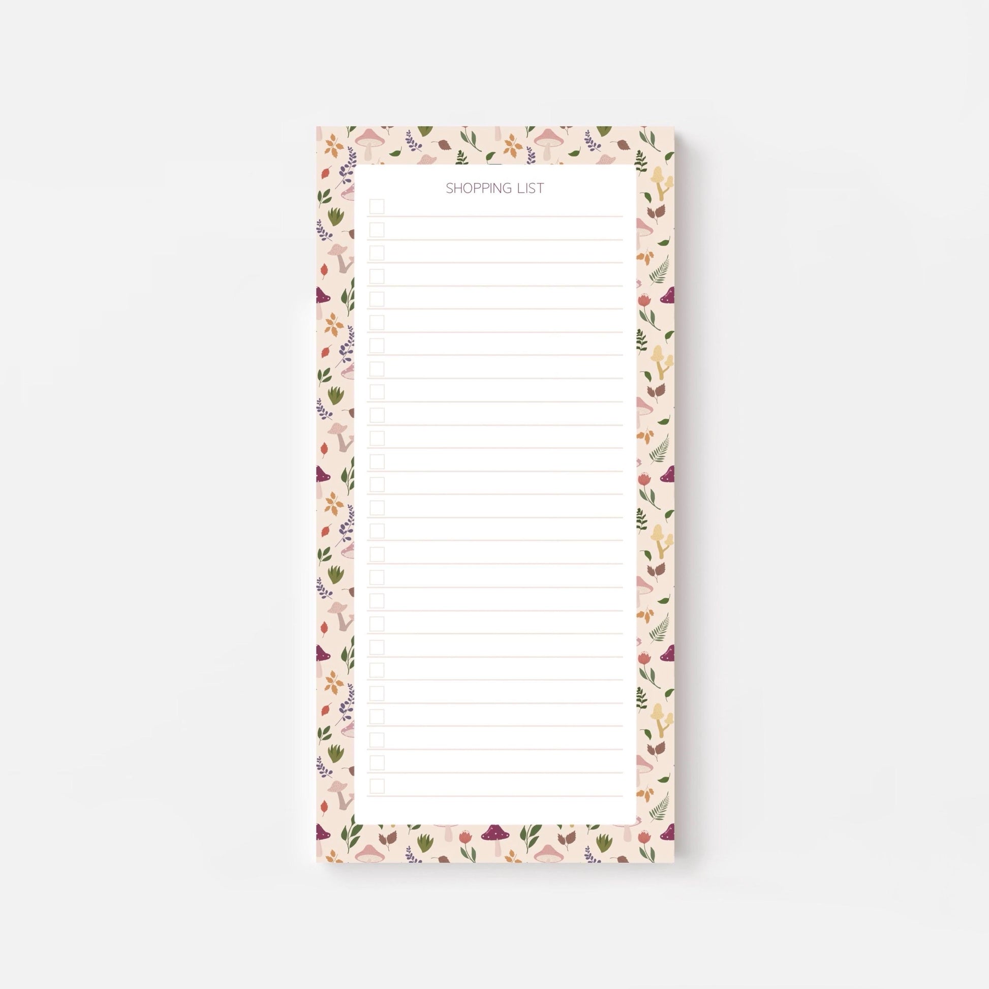 Autumn foliage-patterned shopping list notepad on a white background