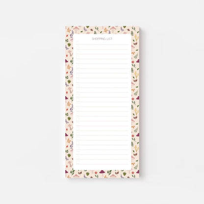 Autumn foliage-patterned shopping list notepad on a white background