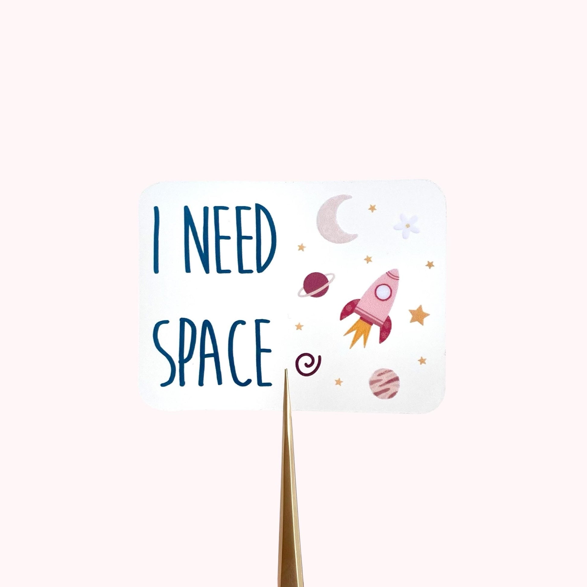 Sticker with 'I Need Space' text and space-themed illustrations on a white background
