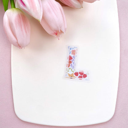 Letter 'L' shaped sticker with floral design on a white background with pink tulips