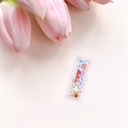 A floral-patterned letter 'I' sticker against a white background