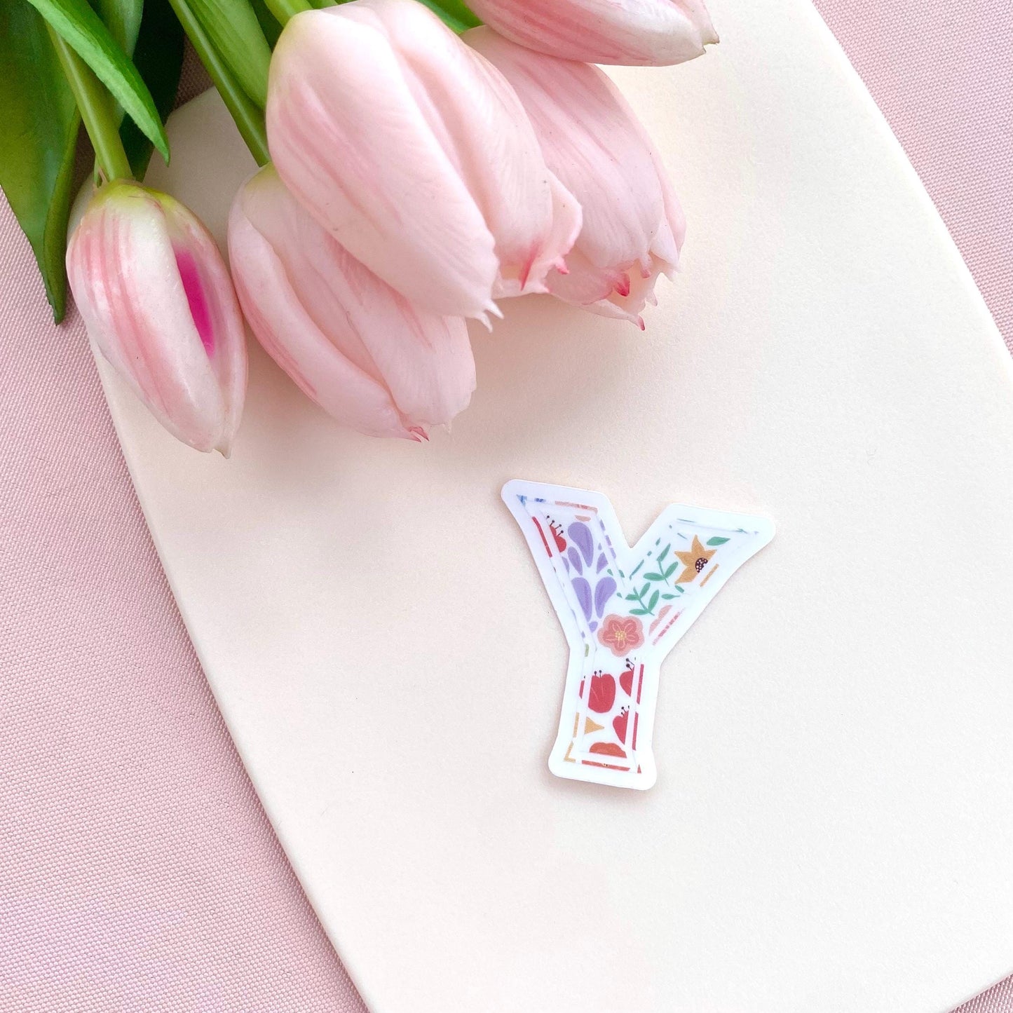 Decorative letter 'Y' sticker with pink tulips on a pink background