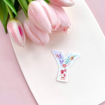 Decorative letter 'Y' sticker with pink tulips on a pink background