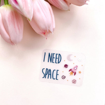 Pink tulips with an 'I NEED SPACE' sticker on a light background