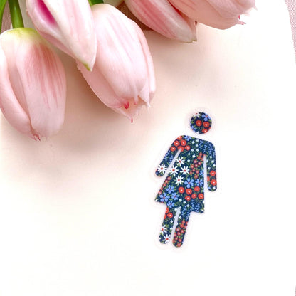 Colourful sticker of a woman symbol with flowers on a white background with pink tulips.