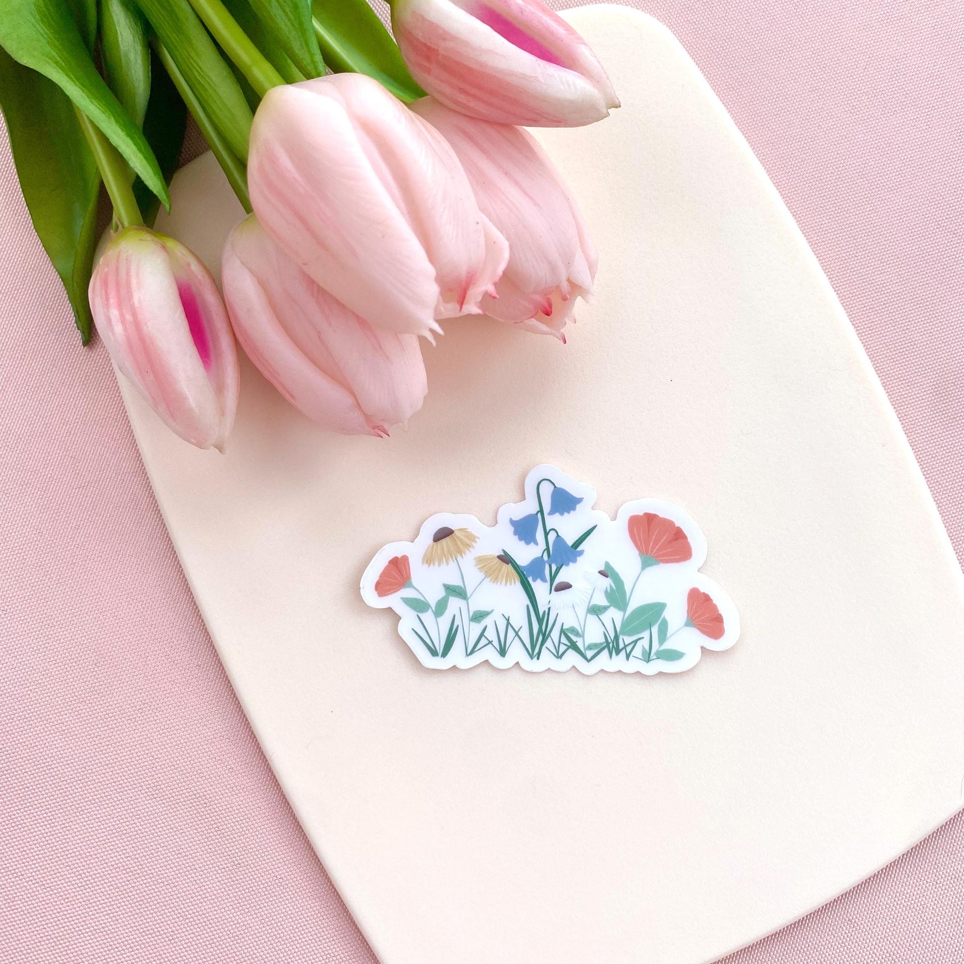 A sticker with colourful garden flowers design on a white background with pink tulips.