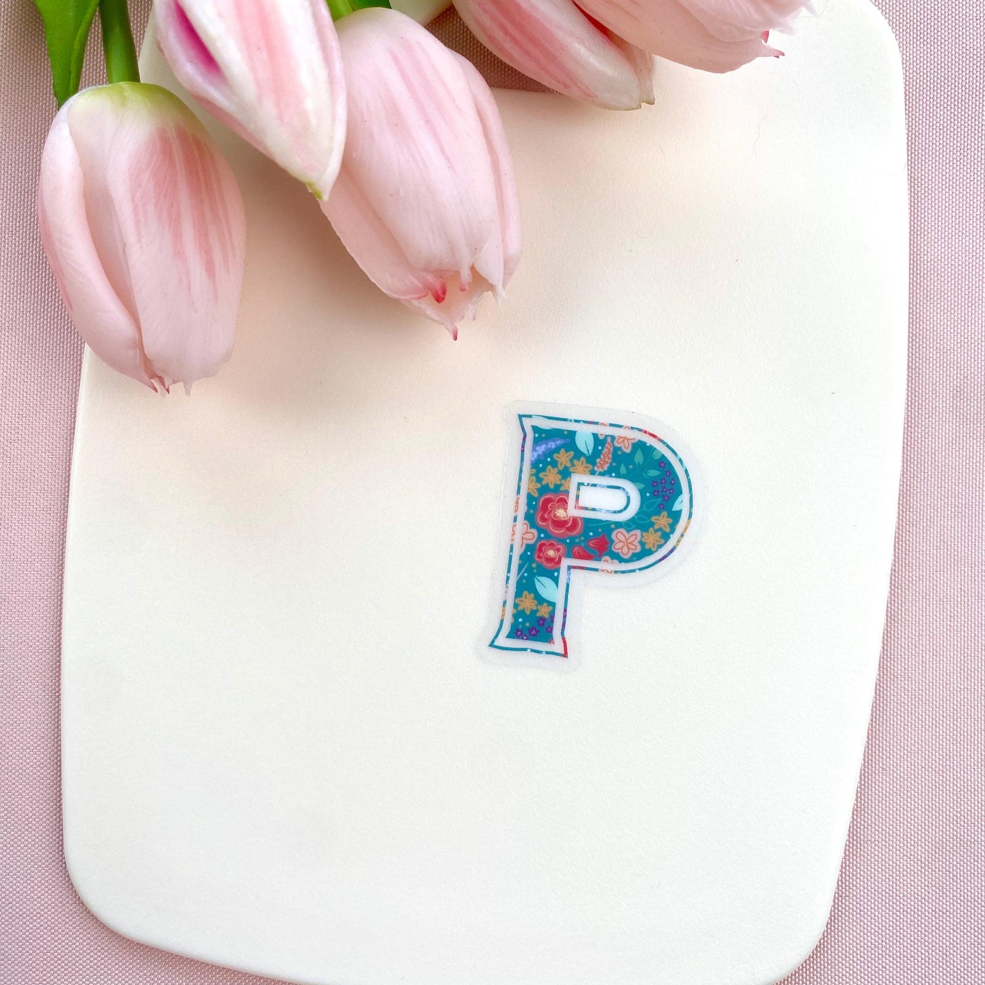 Decorative letter 'P' sticker with floral pattern on a white background