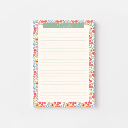 Floral bordered notepad with lined paper on a white background