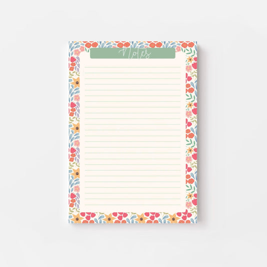 Floral bordered notepad with lined paper on a white background