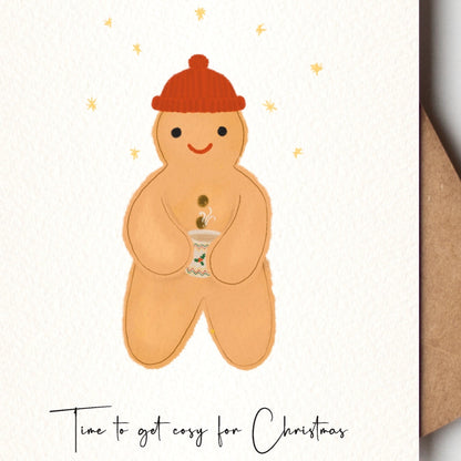 Gingerbread man  with a red hat on a Christmas card with a brown kraft envelope