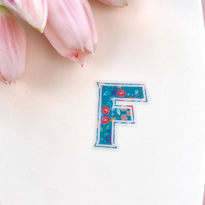 Floral letter 'F' sticker on a white background with pink tulips.