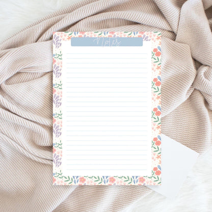 Floral notepad on a textured fabric background