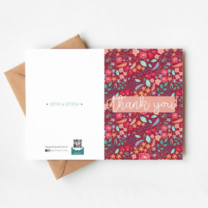 Floral patterned pink card with 'Thank you' text and Ditsy & Stitch branding on the back on a white background.