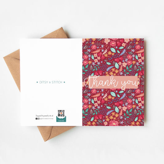 Floral patterned pink card with 'Thank you' text and Ditsy & Stitch branding on the back on a white background.
