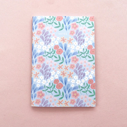 Floral patterned notebook on a pink background