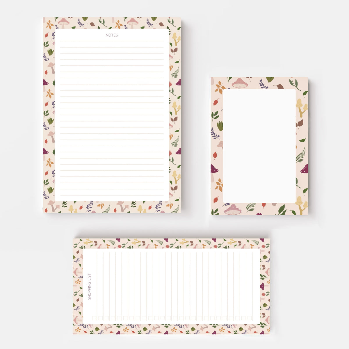 Three floral notepad sheets with lined writing areas and decorative borders with autumnal mushroom and leaves, arranged on a light grey background.