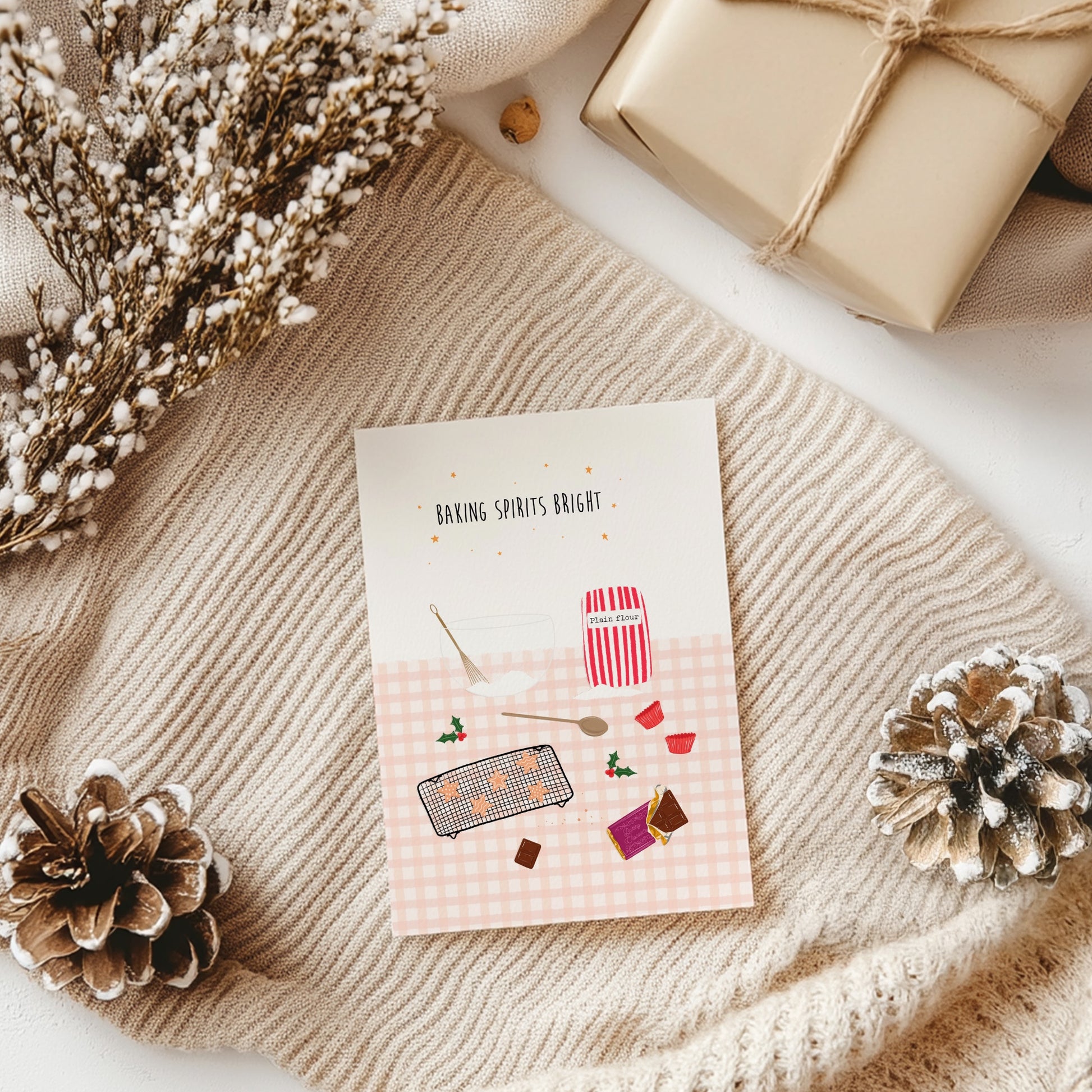 Greeting card with festive baking design on a textured surface with decorative elements and presents