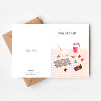 Greeting card with festive baking-themed illustrations and envelope on a white background with a brown kraft envelope.