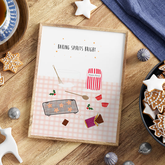 Framed print with Christmas baking-themed design on a wooden table with star cookies, a bowl, whisk, wooden spoon, bag of flour and chocolate.