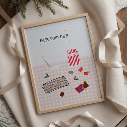 Framed artwork with Christmas baking-themed illustrations on a pink gingham tablecloth background, surrounded by ribbons and greenery.