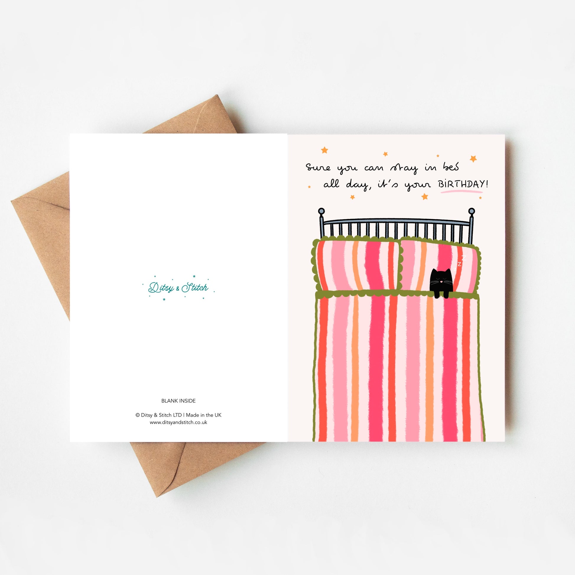 Greeting card with a cartoon bed and cat design