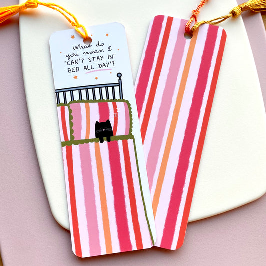 Pink and orange striped bookmark with cartoon cat and 'What do you mean I 'can't stay in bed all day'' text with stars on a white background