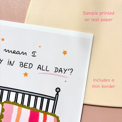 A close-up of a print sample showing part of a bed-themed design with text reading 'What do you mean I CAN’T STAY IN BED ALL DAY?' and an illustration of a bed with a striped duvet. Pink sample-print text notes 'Sample printed on test paper' and 'Includes a thin border.