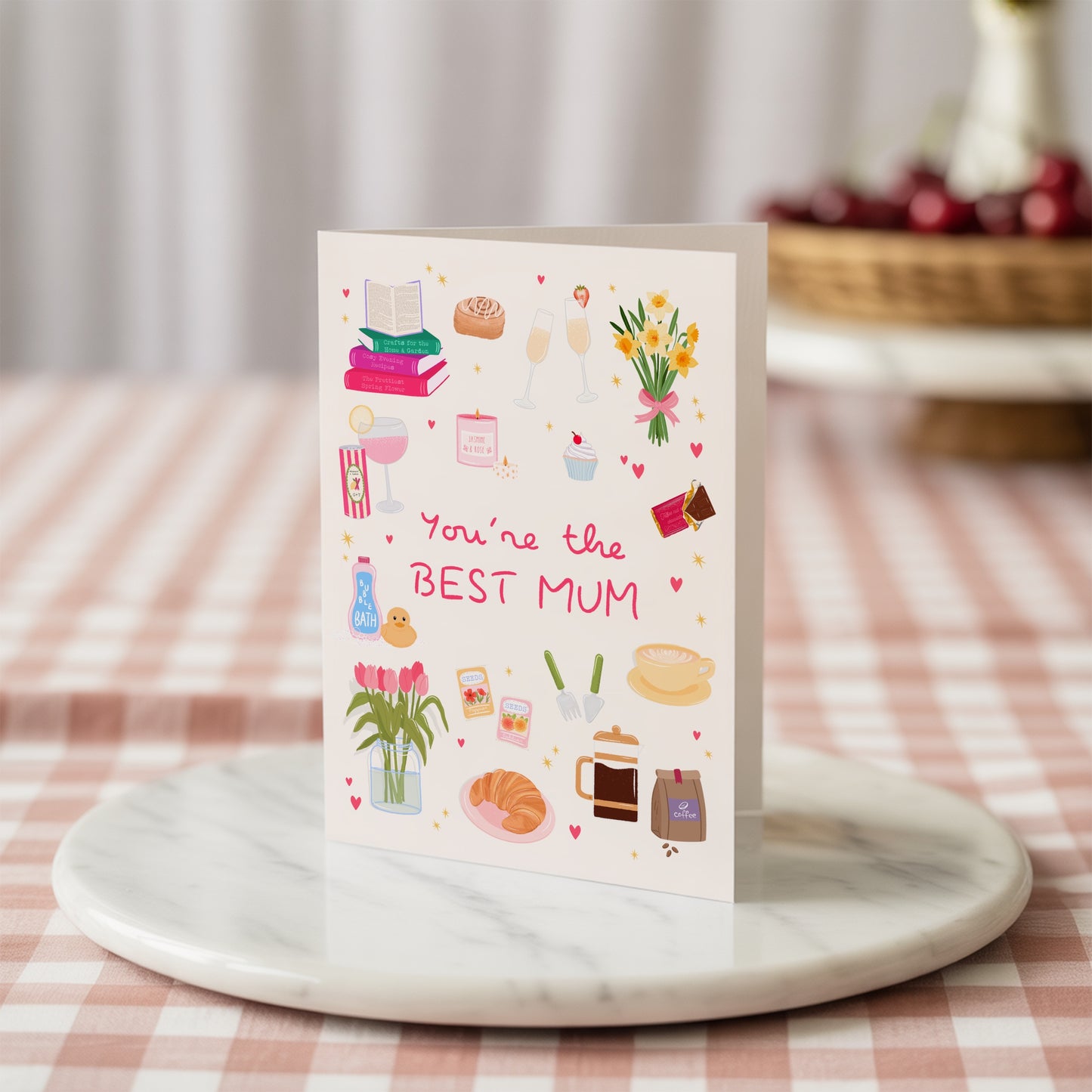 Greeting card with illustrations and text 'You're the BEST MUM' on a marble coaster.