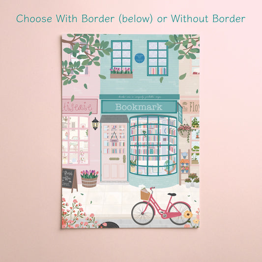 A vertical art print featuring a whimsical illustration of a bookshop street scene with a pink bicycle, hanging flowers, and a turquoise storefront labeled 'Bookmark'. The print is displayed against a soft pink background with text at the top reading 'Choose With Border (below) or Without Border'.