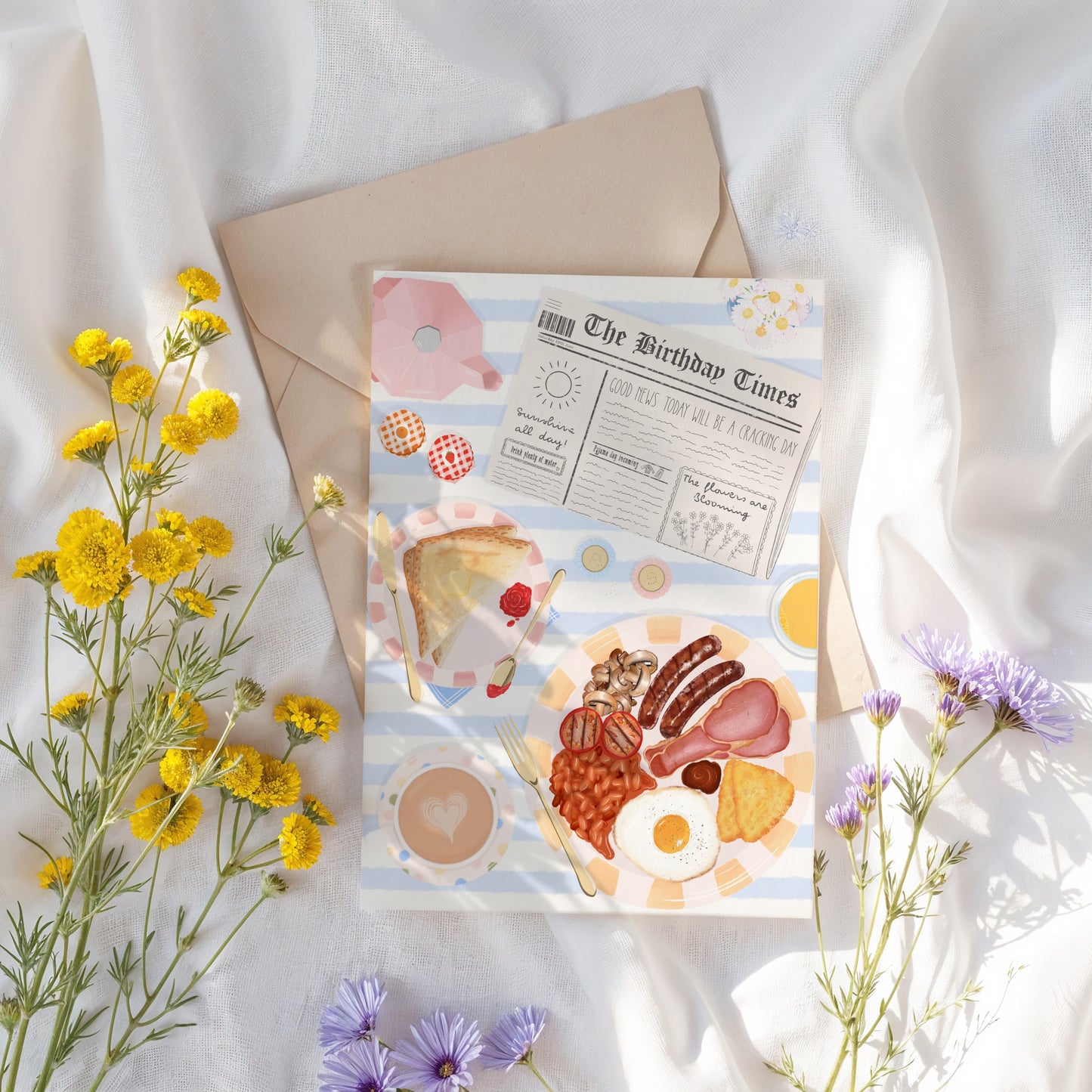Birthday greeting card with breakfast illustration on a white fabric background with flowers.