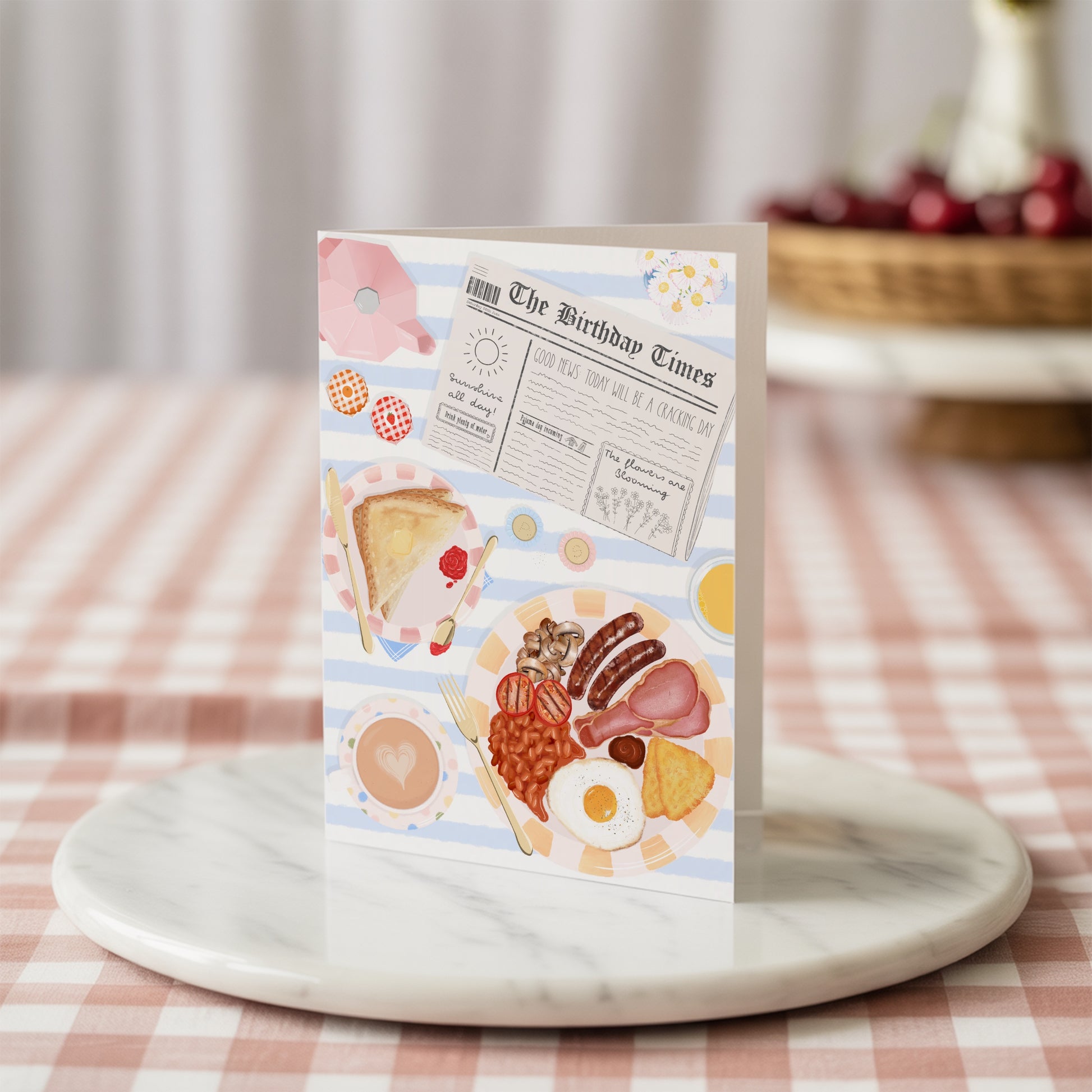 Greeting card with breakfast food illustrations on a marble surface with a checkered tablecloth background