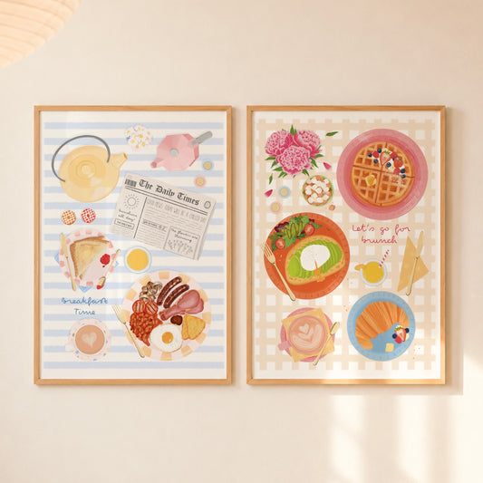 Two framed pastel breakfast-themed art prints hanging side by side on a light beige wall. The left print has light blue stripes with illustrations of a teapot, pink teapot, newspaper, toast, eggs, and bacon. The right pink has yellow gingham with coffee, a croissant, avocado toast, and waffles with berries and syrup.
