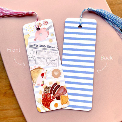 Two bookmarks showing the front and back designs on a pink surface.