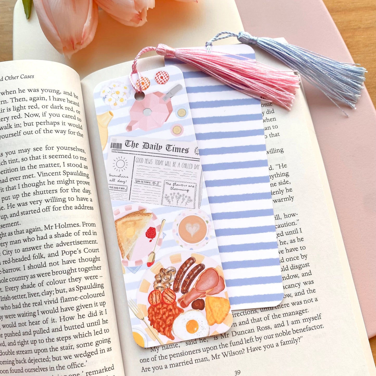A colourful blue striped bookmark featuring food illustrations on an open book.