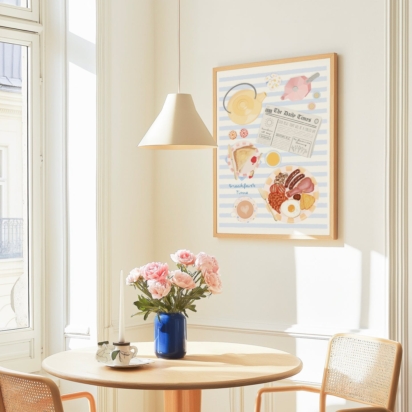 Room interior with a table, chairs, and a vase of flowers under a framed breakfast themed illustration picture on the wall.