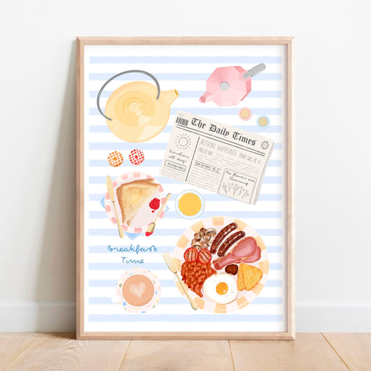 A framed art print featuring a whimsical illustration of a breakfast scene with blue and white stripes, a yellow teapot, a newspaper, toast, eggs, bacon, beans, and a cup of coffee, leaning against a white wall on a light wood floor.