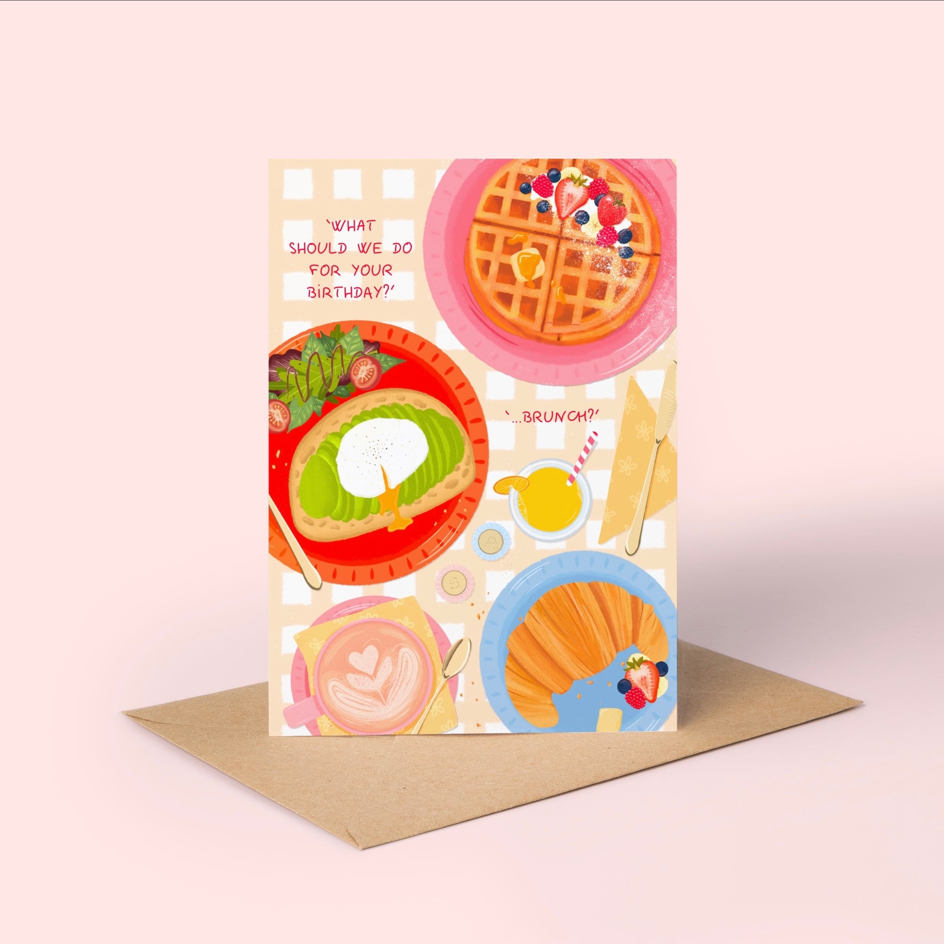 Birthday greeting card with brunch food illustrations and a brown kraft envelope on a light pink background.